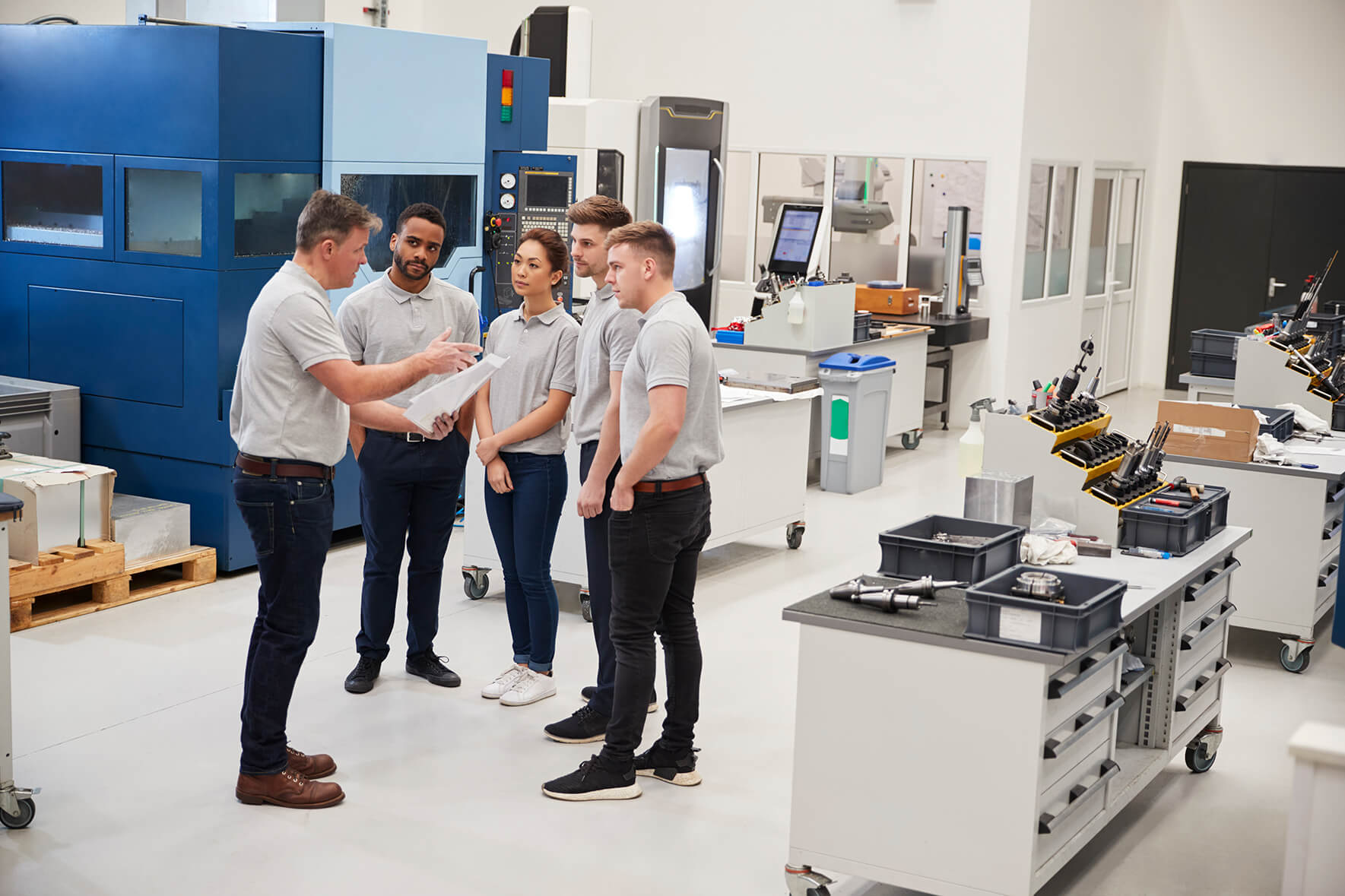 Engineering team meeting on factory floor