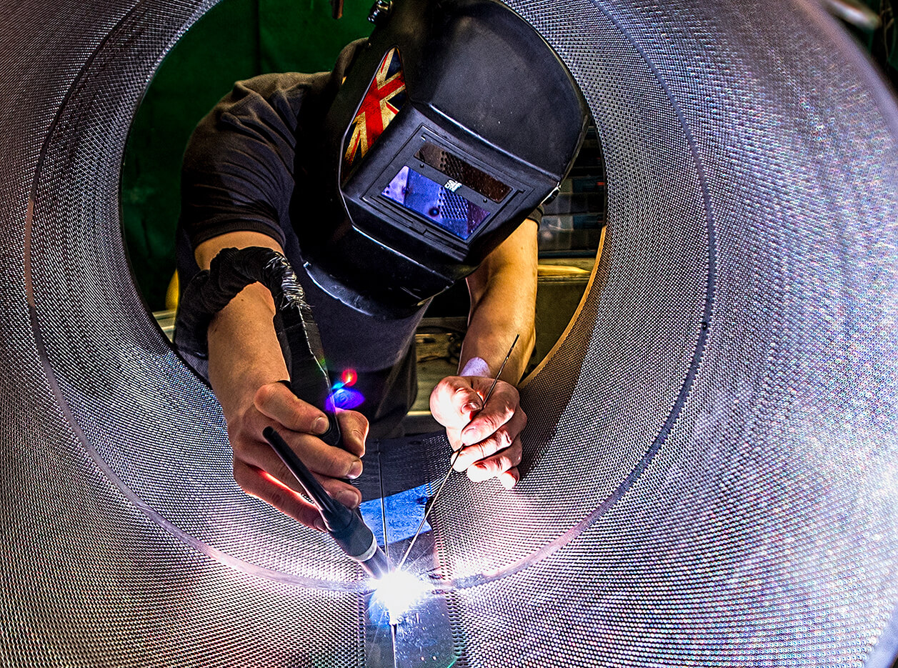 Man welding a filter unit